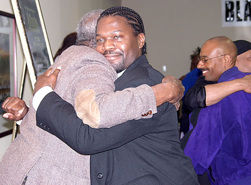 Brothers hugging after exercise, Los Angeles, California Black Business Seminar