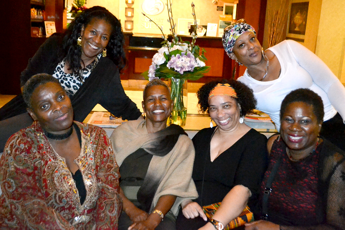 Sisters posing on couch at event, 2015 Buy Black Movement San Diego Launch