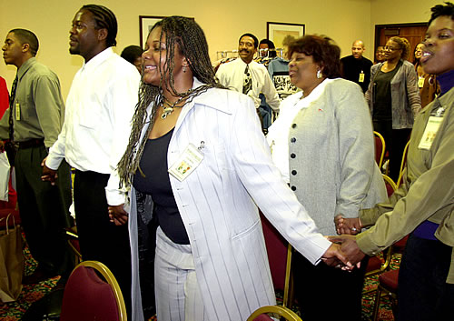 Audience holding hands, Los Angeles, California Black Business Seminar
