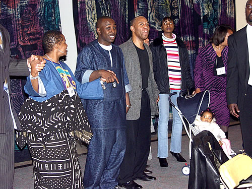 Audience holding hands and singing, New York City Black Business Seminar