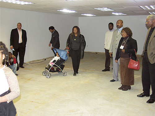 Members listening to Delxino explain the function of Production Room 1, Construction Tour of Atlanta TAG TEAM Marketing Center