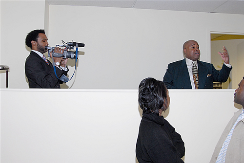 Delxino speaking from DJ booth in the TAG TEAM Presenation Room, TAG TEAM Marketing Atlanta Facility Grand Opening