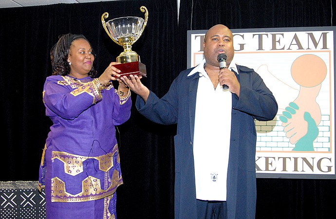 Delxino And Debbie Presenting TAG Award Trophy Delxino And Debbie Presenting TAG Award Trophy