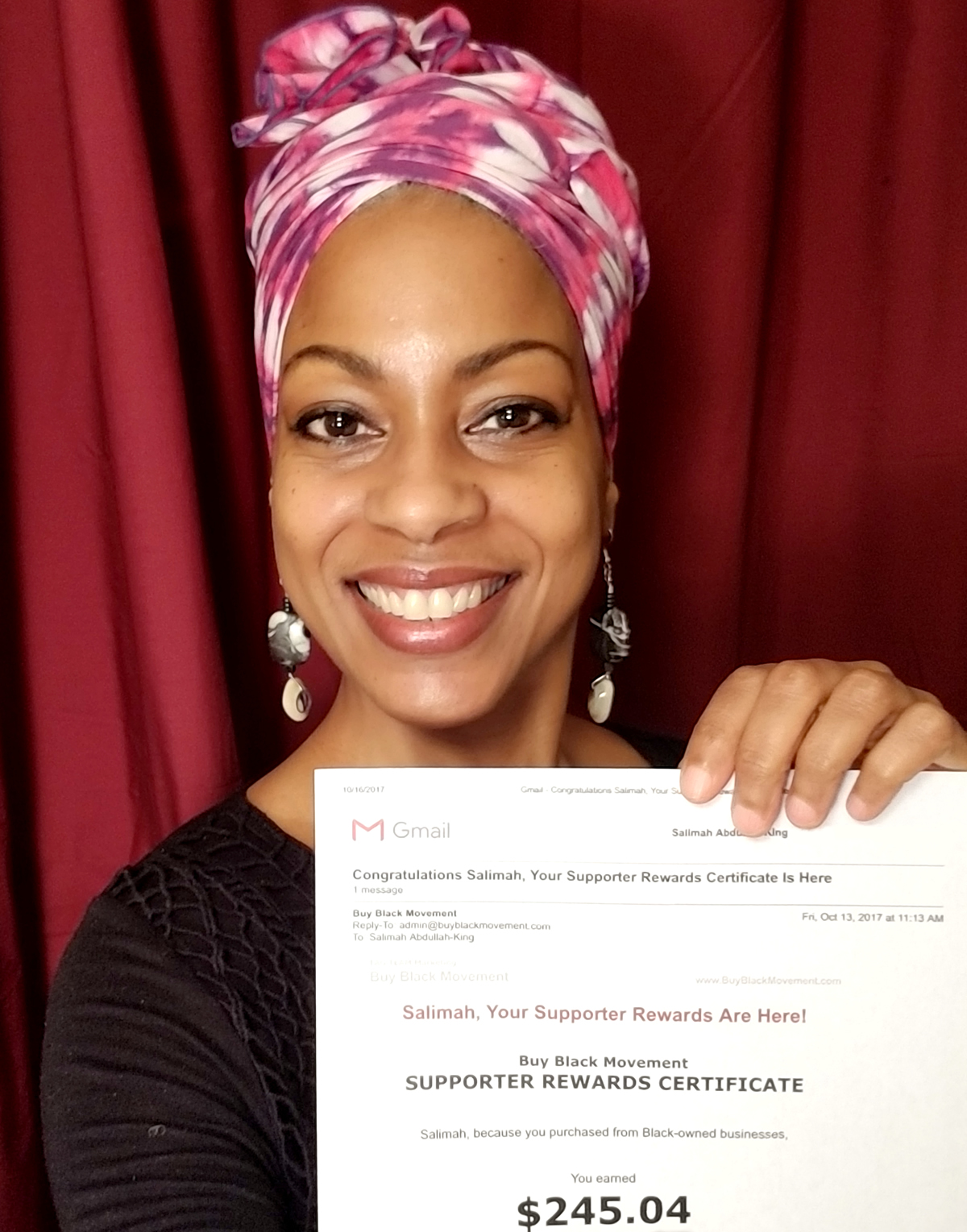 Salimah holding rewards certificate