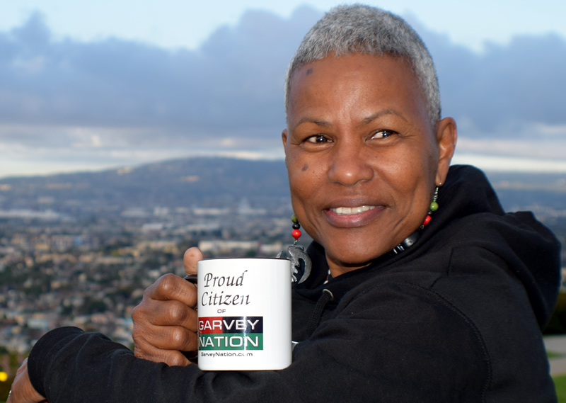 Citizen Holding 'Proud Citizen of Garvey Nation' Mug