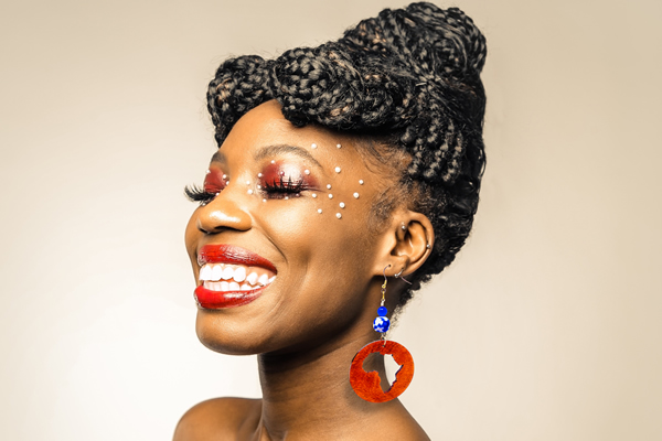 Sister Turned To The Side Wearing Africa Earrings