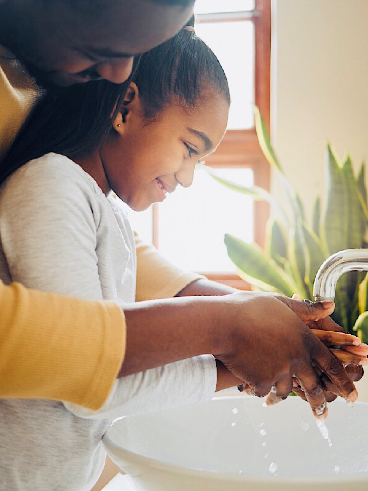 Man and daughter washing hands