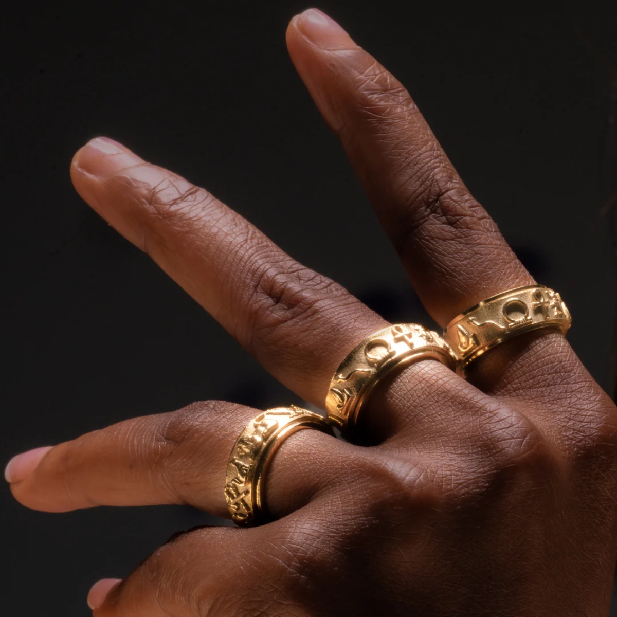 Hand wearing 3 rings