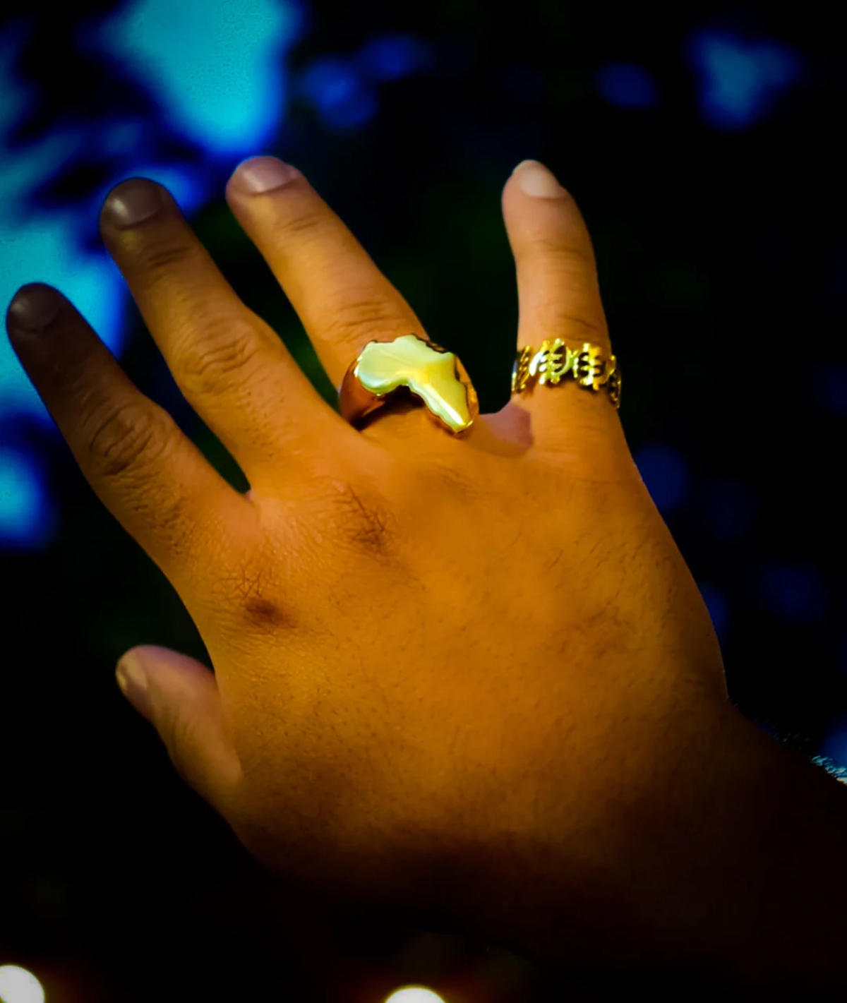 Hand wearing adinkra ring and African King Ring